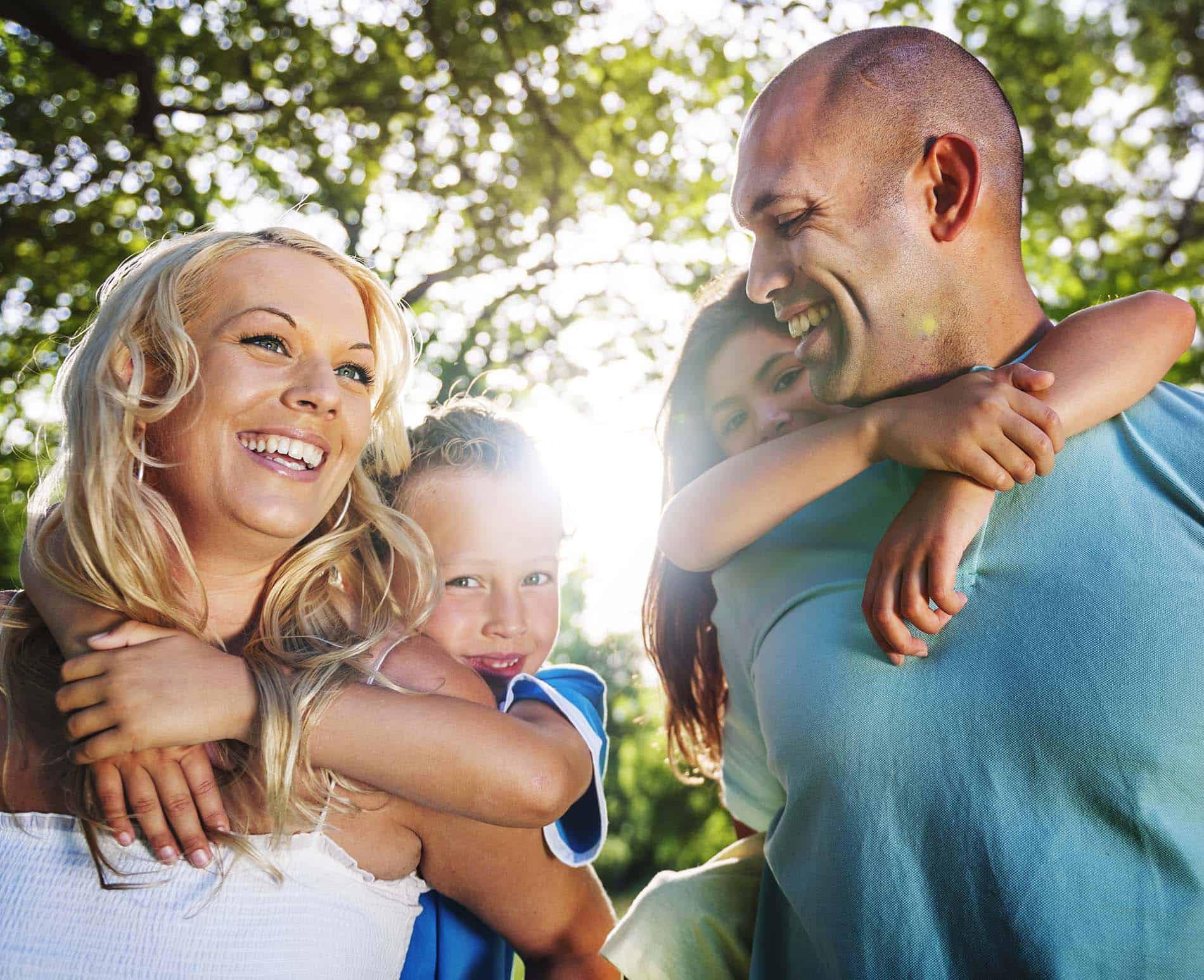 Family playing in the park after donated embryo recipient adoption